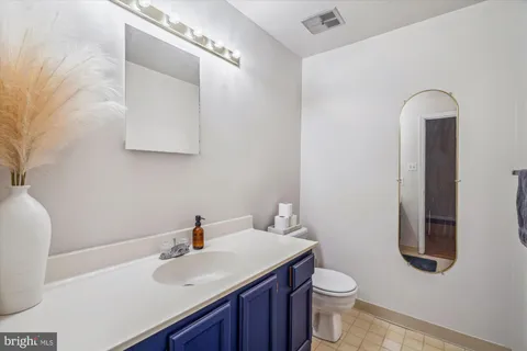 a bathroom with a sink a toilet and mirror