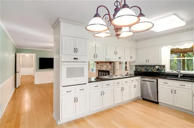 a view of a livingroom with wooden floor and a ceiling fan