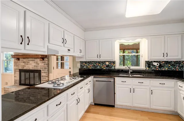 a kitchen with stainless steel appliances granite countertop a stove and a refrigerator