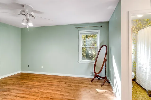 a spacious bedroom with a bed and a chandelier
