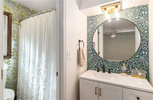 a view of a house with a large window and wooden fence