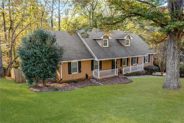 a front view of house with yard and green space