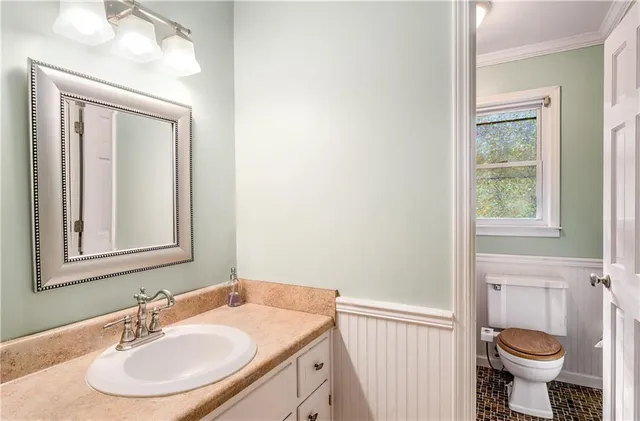 an aerial view of a house with a yard and large trees