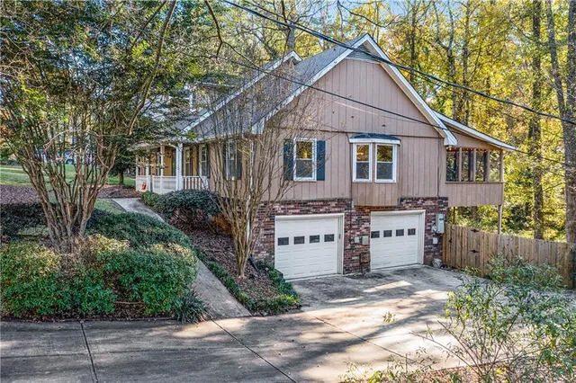 a front view of a house with a yard and trees