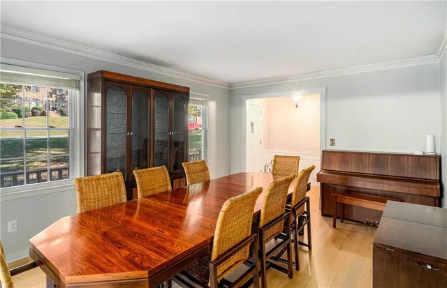 a view of a dining room with furniture and chandelier