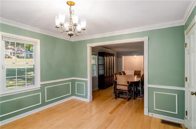 a kitchen with white cabinets and sink