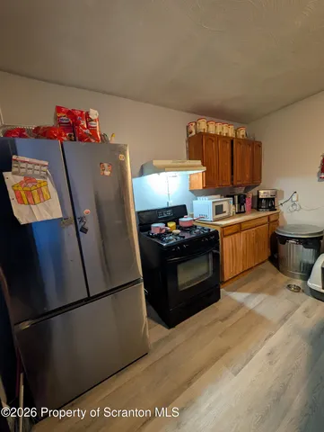 a kitchen with stainless steel appliances granite countertop a refrigerator stove a sink dishwasher and a refrigerator