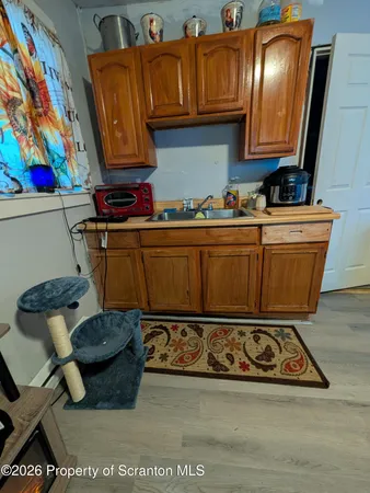 a view of kitchen with stainless steel appliances granite countertop a stove a sink and a microwave