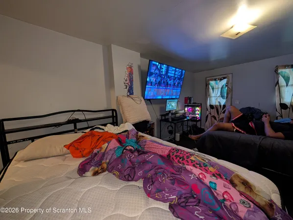 a bedroom with a bed and dresser with window