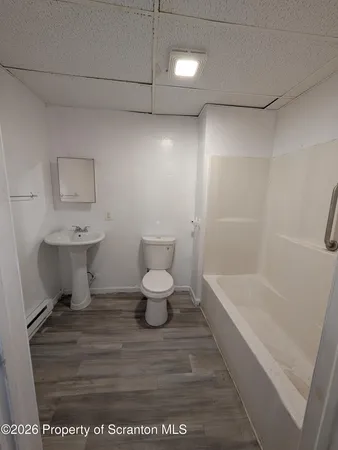 a bathroom with a sink a toilet and a bathtub