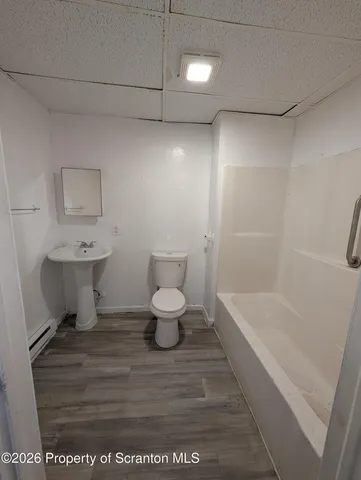a bathroom with a sink a toilet and a bathtub