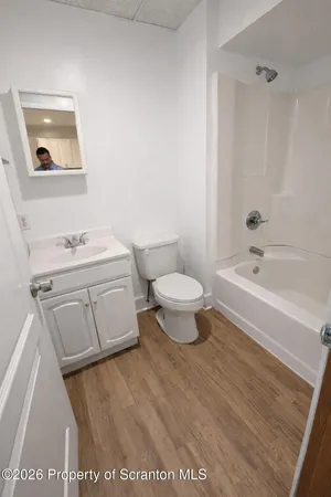 a bathroom with a sink toilet a mirror and shower