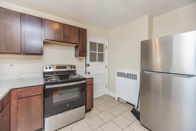 a kitchen with a refrigerator stove and cabinets