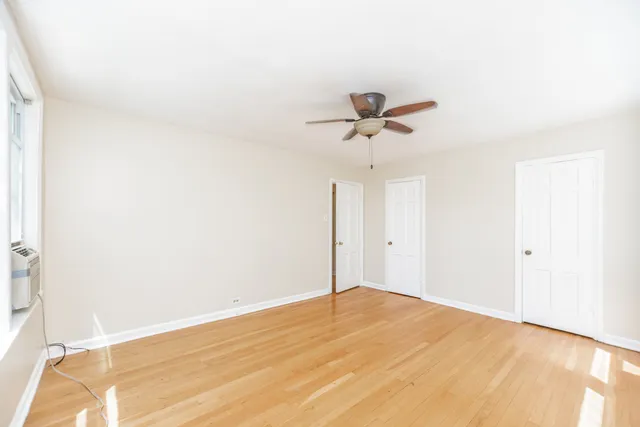 a view of a room with a ceiling fan and a window