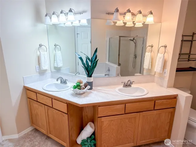 a bathroom with a tub sink and mirror