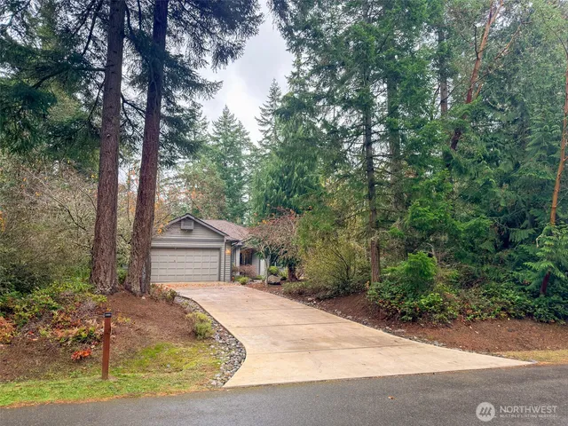 an aerial view of a house with a yard and garden