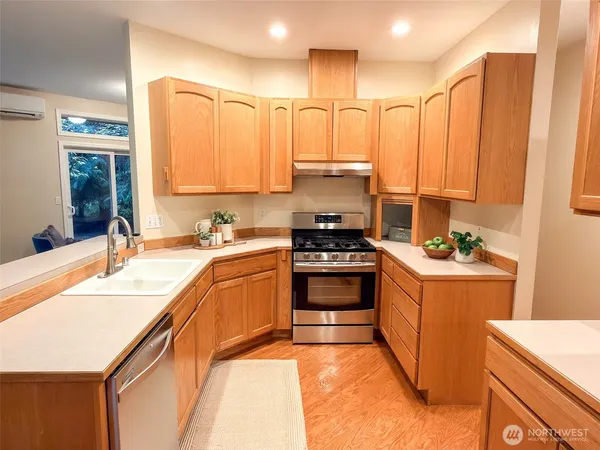 a kitchen with stainless steel appliances granite countertop a sink and cabinets