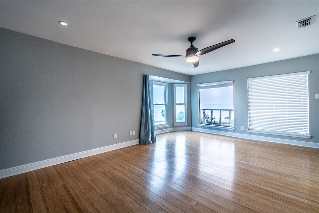 930 Waterview Street Portland, TX 78374 - Photo 11 of 38 a view of an empty room with wooden floor and a window