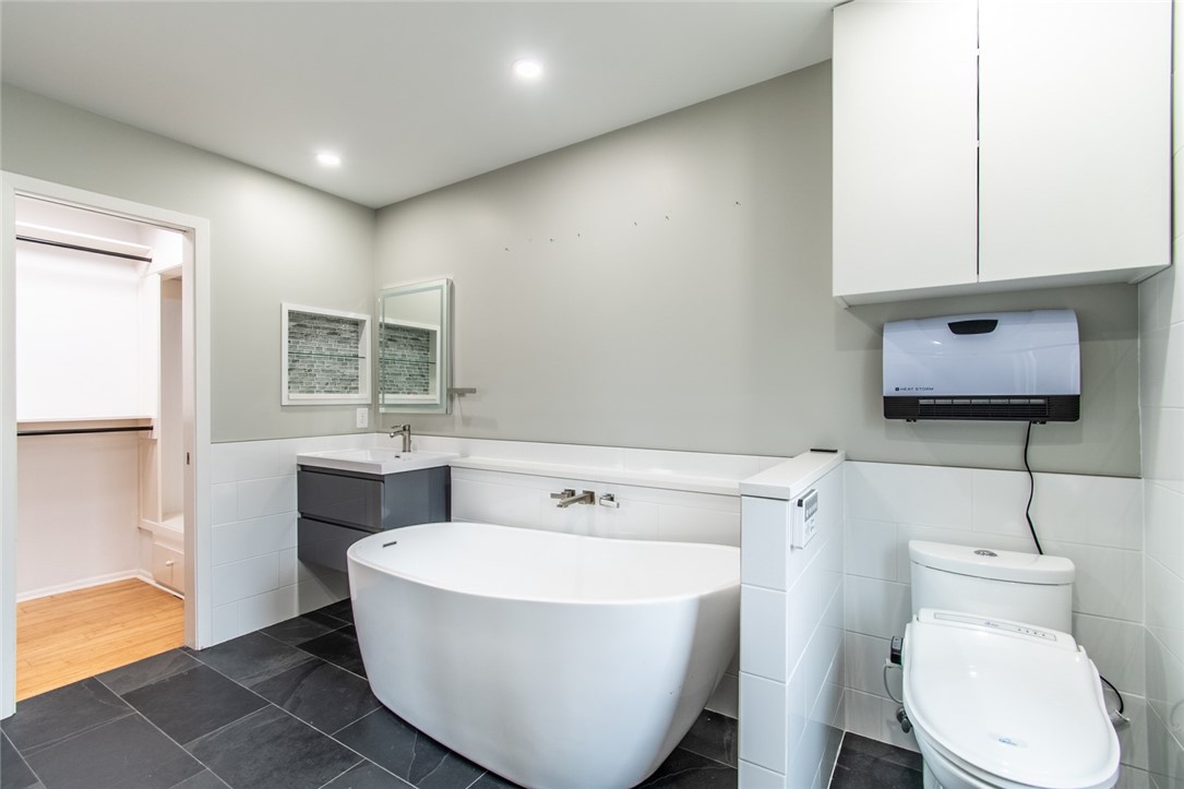 930 Waterview Street Portland, TX 78374 - Photo 14 of 38 a bathroom with a toilet a sink and mirror