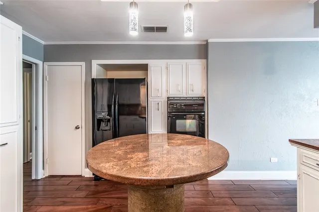 a kitchen with a table and chairs