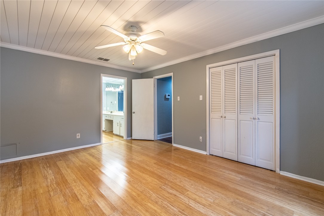 930 Waterview Street Portland, TX 78374 - Photo 23 of 38 a view of an empty room with wooden floor and a ceiling fan