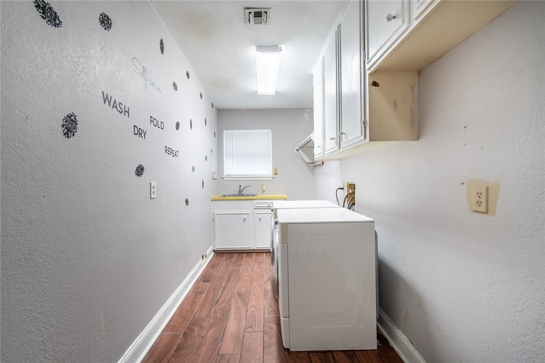 930 Waterview Street Portland, TX 78374 - Photo 27 of 38 a utility room with cabinets washer and dryer