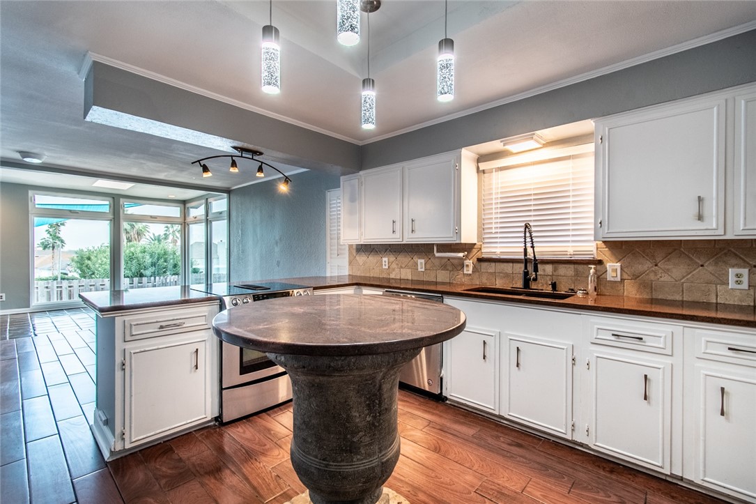 930 Waterview Street Portland, TX 78374 - Photo 35 of 38 a kitchen with a sink window and cabinets