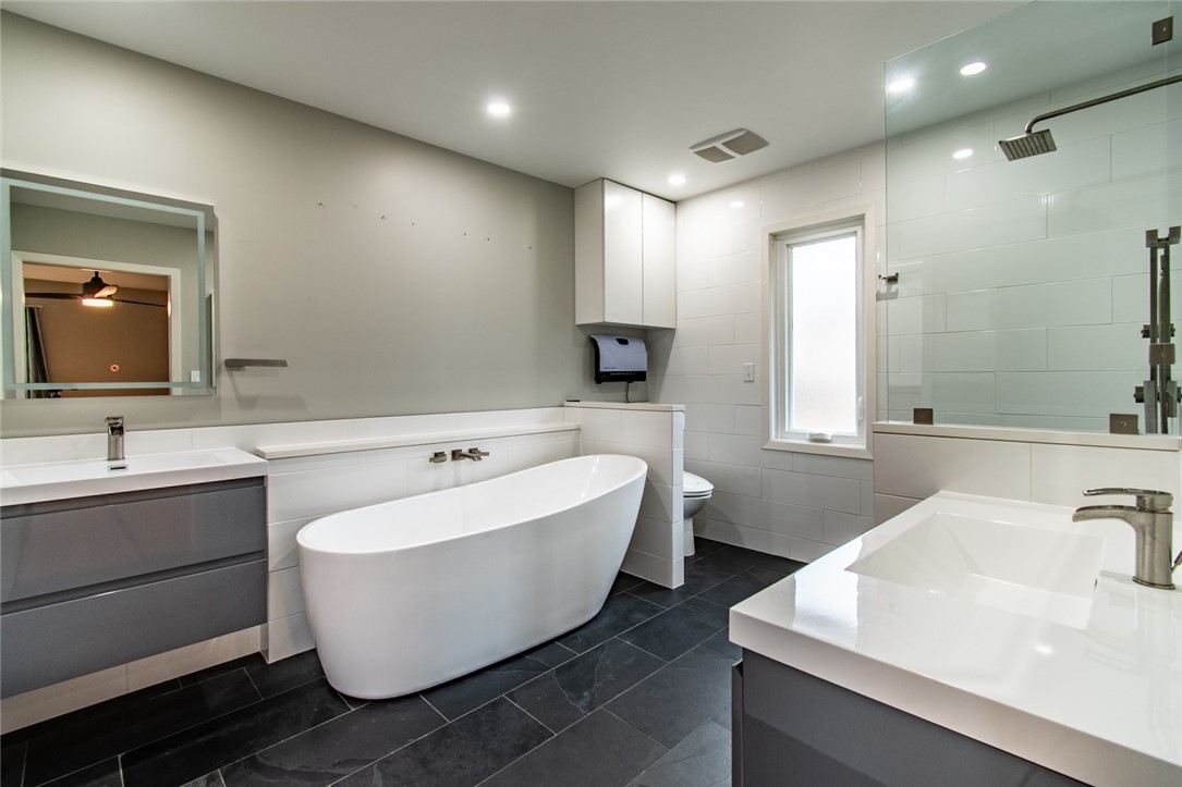 930 Waterview Street Portland, TX 78374 - Photo 38 of 38 a bathroom with a white tub sink and mirror