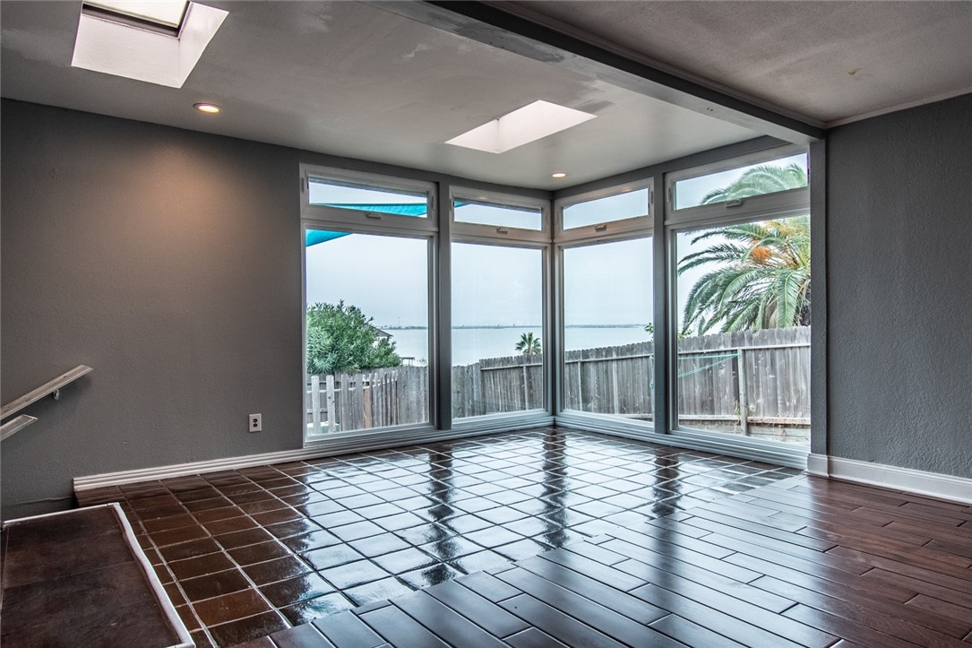 930 Waterview Street Portland, TX 78374 - Photo 10 of 38 a view of an empty room with wooden floor and a window