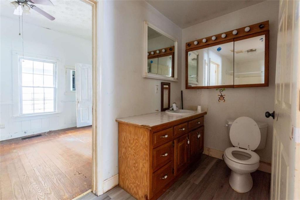 1829 Williams Avenue East Point, GA 30344 - Photo 12 of 21 a bathroom with a toilet sink vanity and mirror