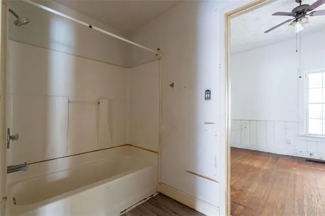 a bathroom with a bathtub and a shower