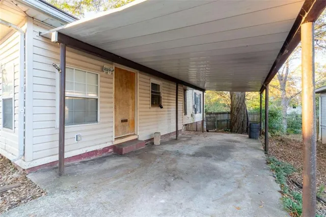 a view of a house with porch and floor to ceiling window