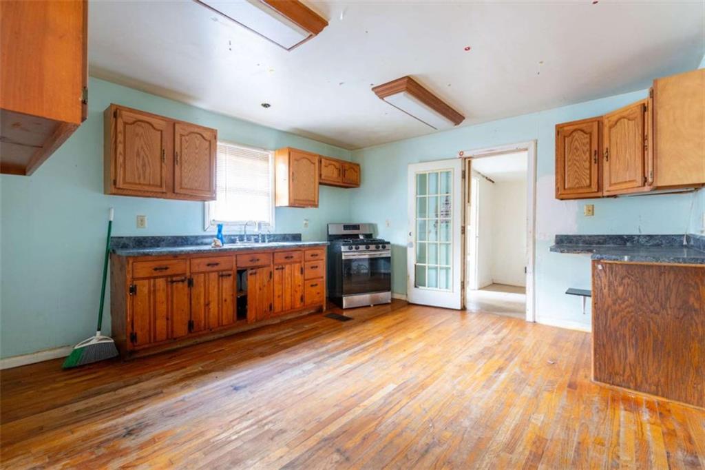 1829 Williams Avenue East Point, GA 30344 - Photo 8 of 21 a kitchen with granite countertop wooden floors and a sink