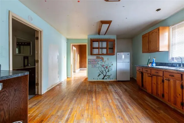 a view of a kitchen with furniture and wooden floor