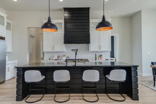 a kitchen with stainless steel appliances white cabinets and a stove