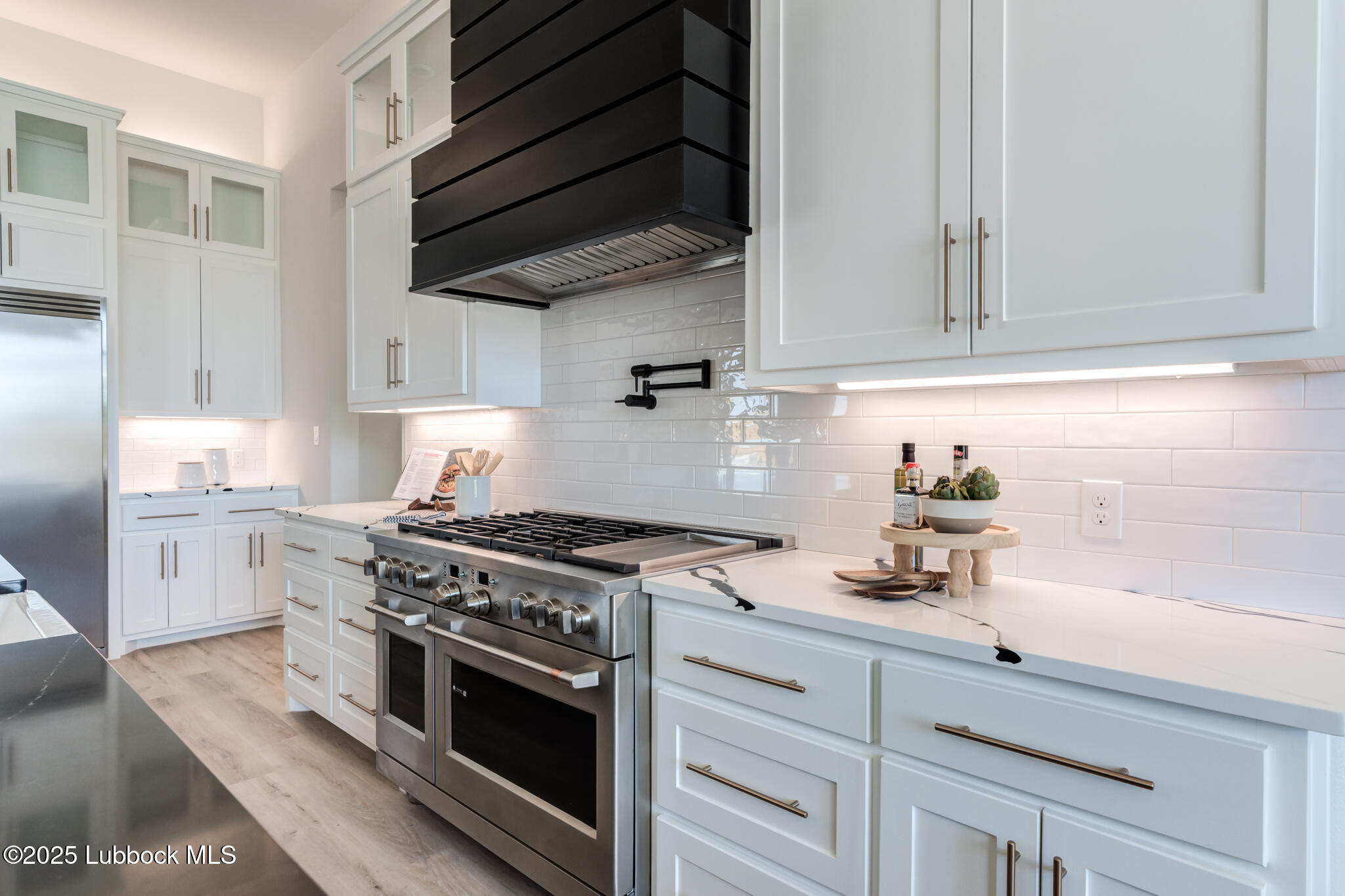 3902 148th Street Lubbock, TX 79423 - Photo 16 of 83 a kitchen with stainless steel appliances white cabinets and a stove