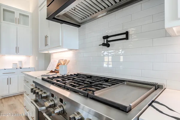 a view of a kitchen with sink cabinets and wooden floor