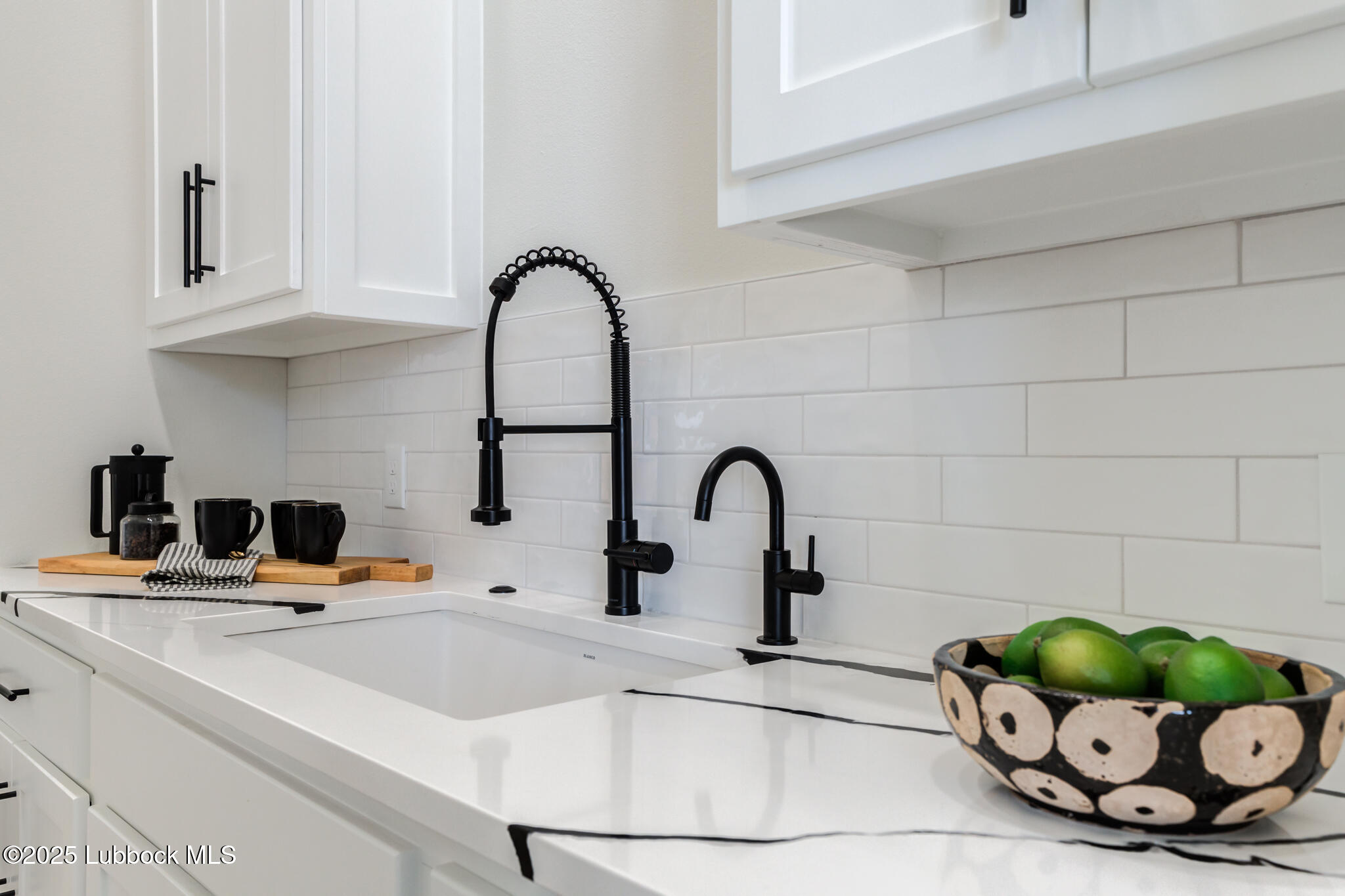 3902 148th Street Lubbock, TX 79423 - Photo 20 of 83 a kitchen with a faucet a sink and white cabinets