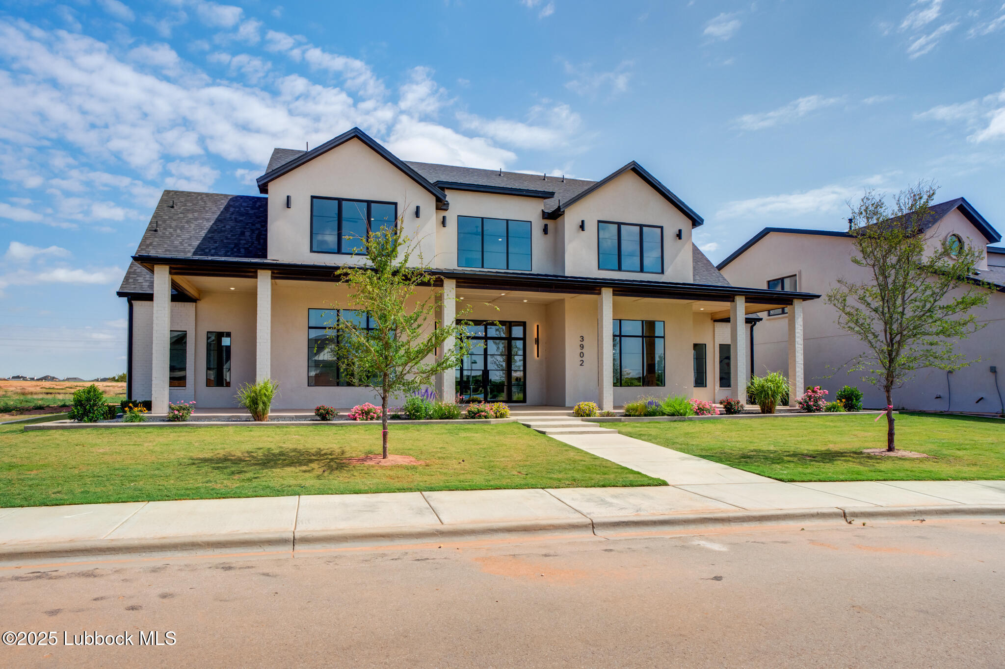 3902 148th Street Lubbock, TX 79423 - Photo 2 of 83 front view of a brick house with a yard