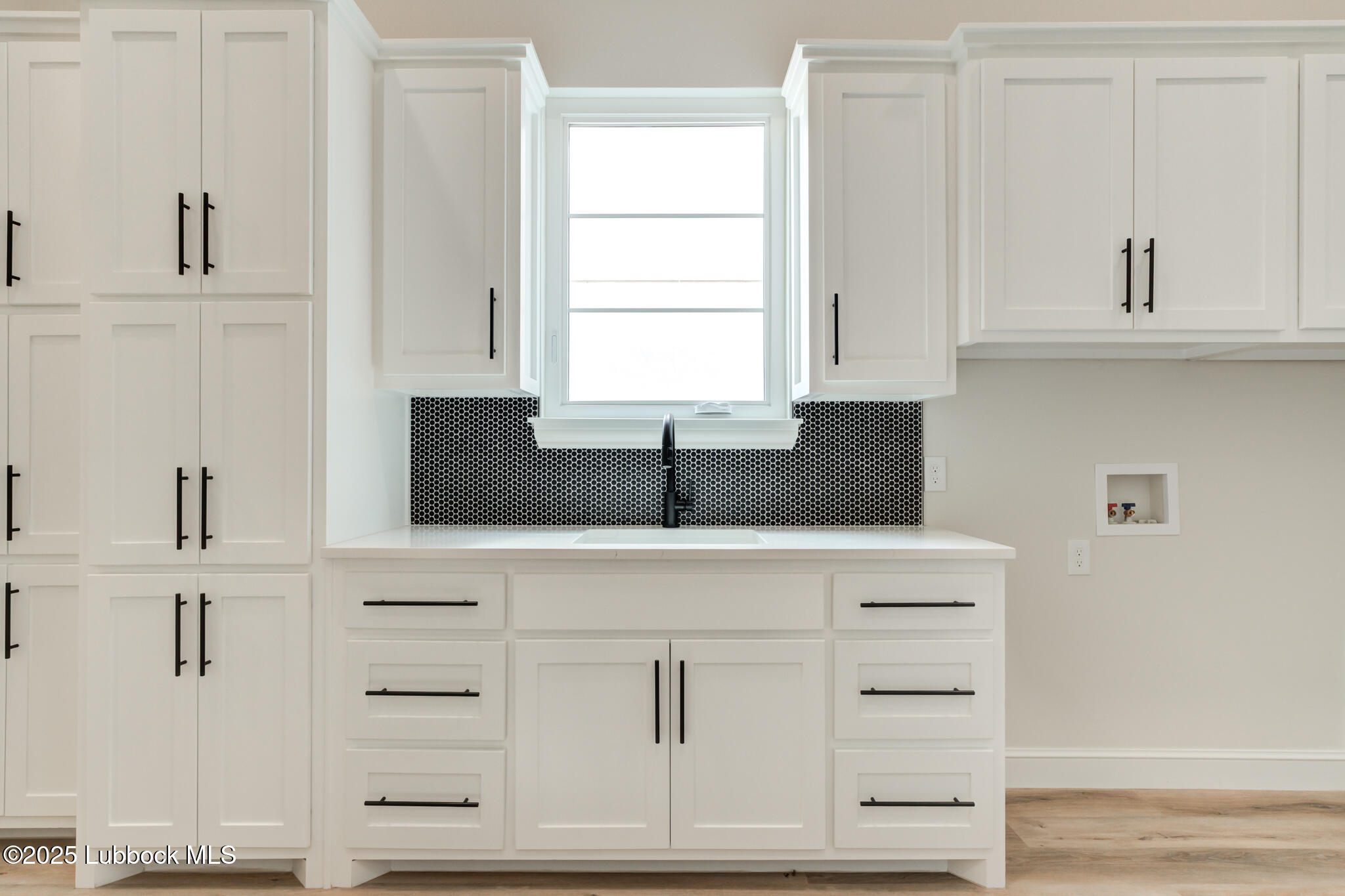 3902 148th Street Lubbock, TX 79423 - Photo 21 of 83 a kitchen with white cabinets and sink