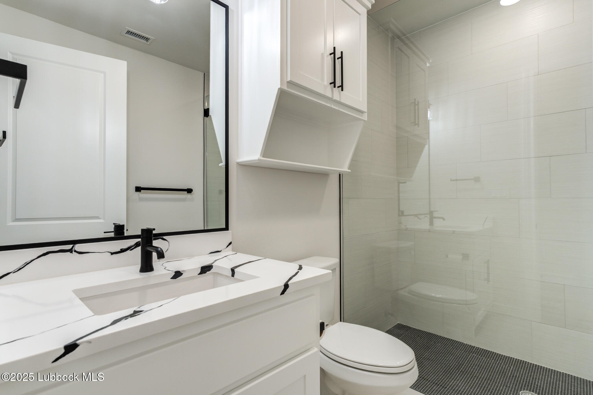 3902 148th Street Lubbock, TX 79423 - Photo 27 of 83 a bathroom with a sink a toilet and shower