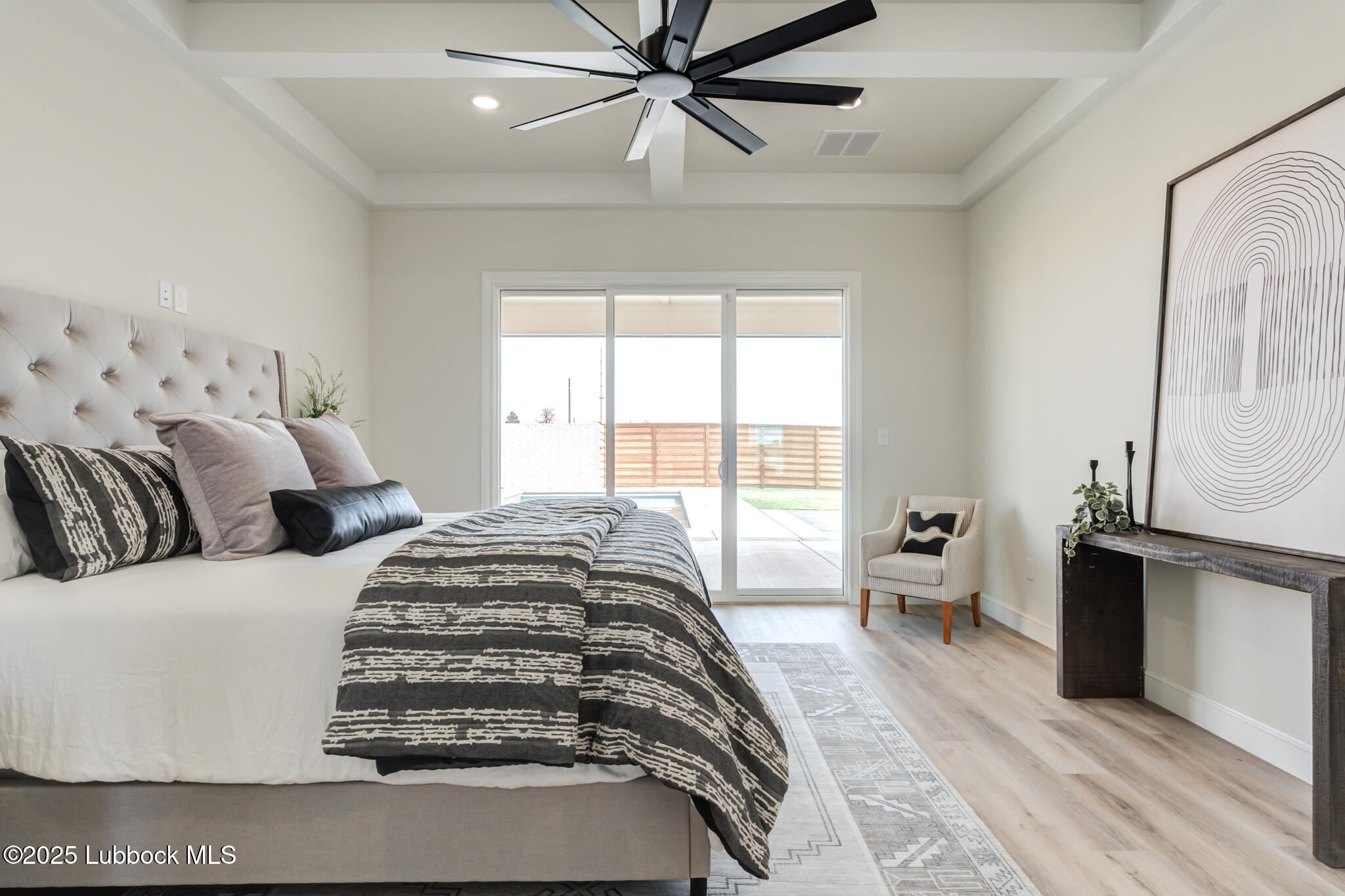 3902 148th Street Lubbock, TX 79423 - Photo 32 of 83 a bedroom with a large bed and a chandelier