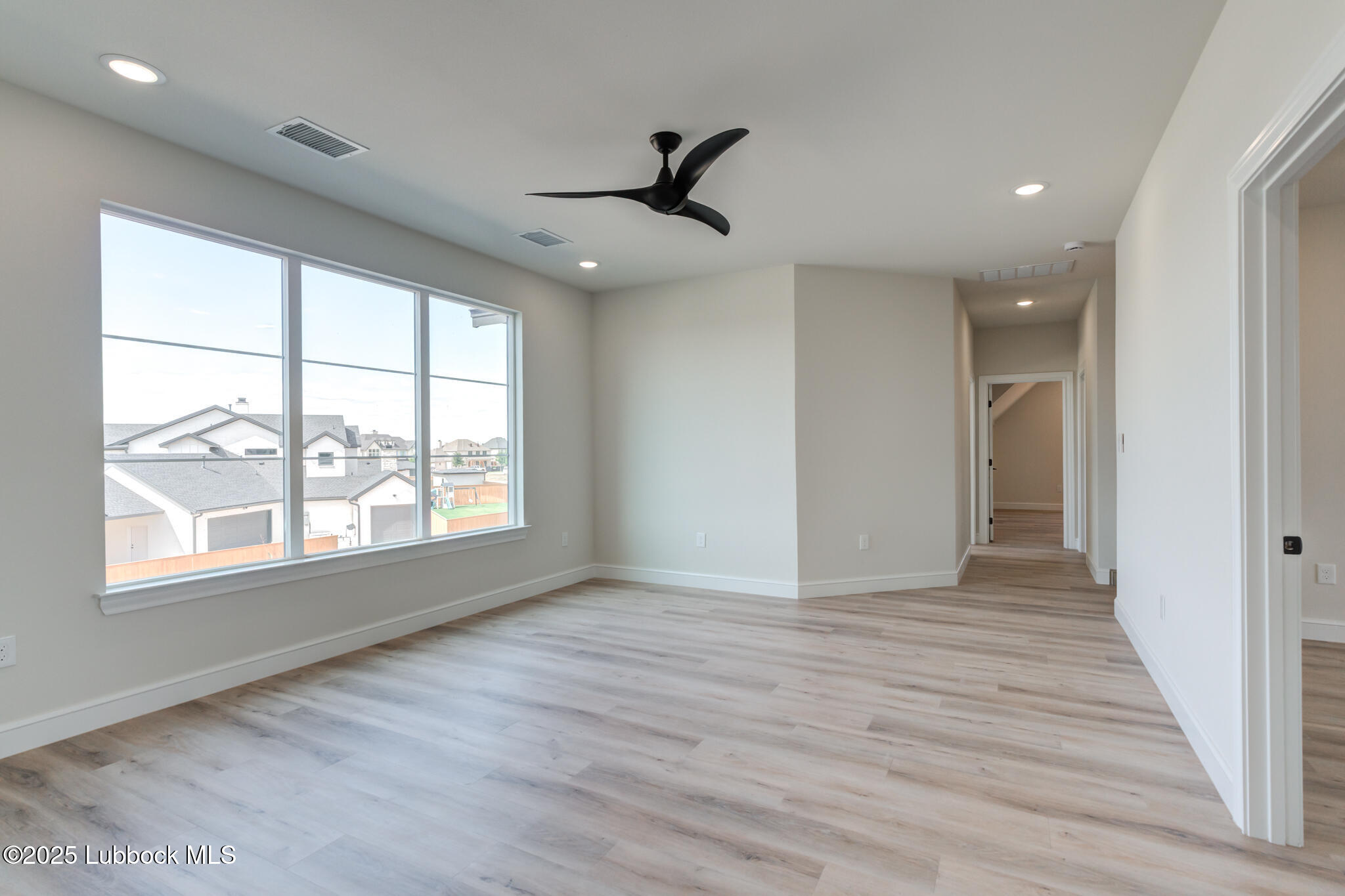 3902 148th Street Lubbock, TX 79423 - Photo 43 of 83 an empty room with wooden floor cabinet and windows