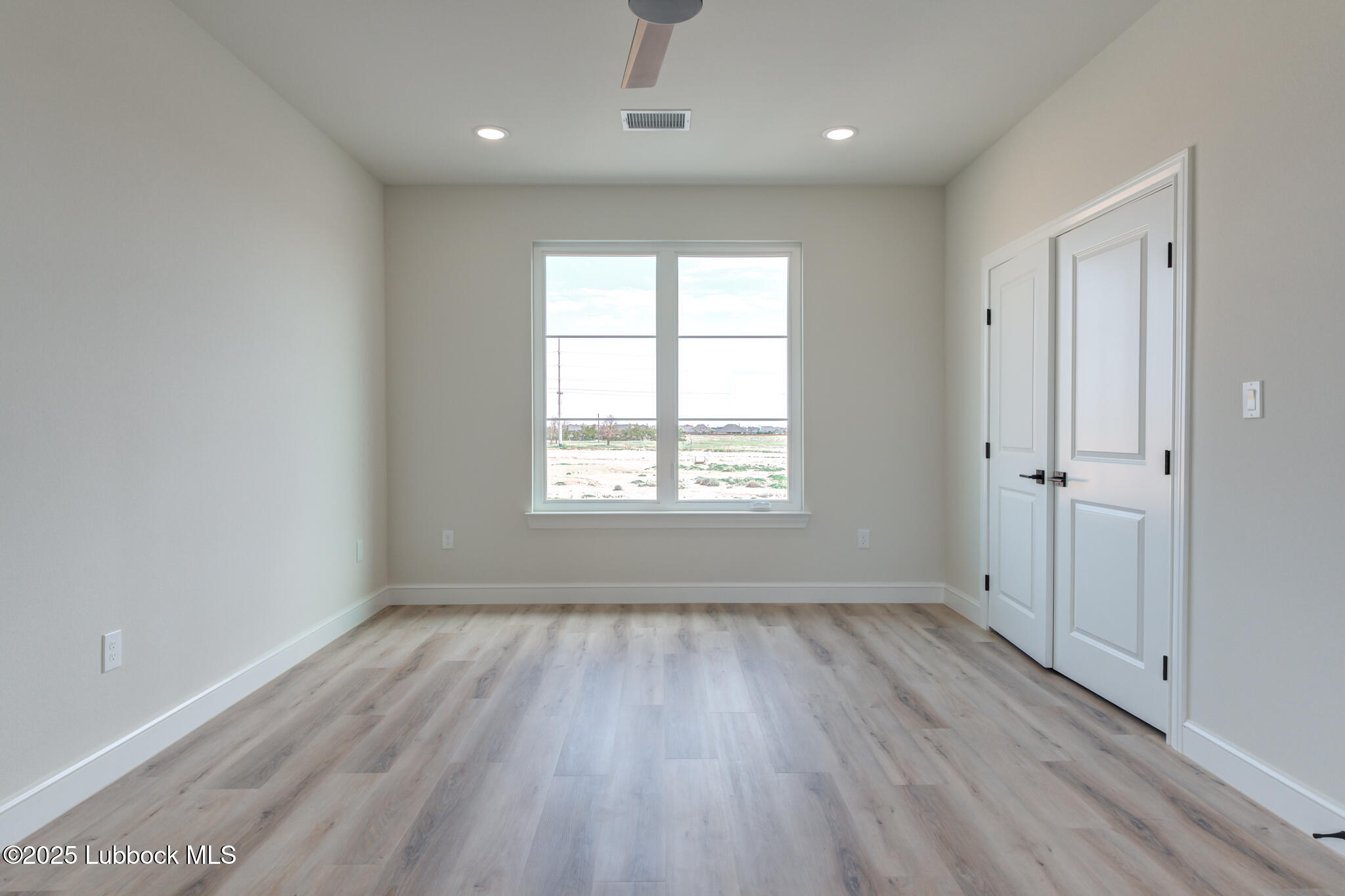 3902 148th Street Lubbock, TX 79423 - Photo 53 of 83 a view of an empty room with wooden floor and a window