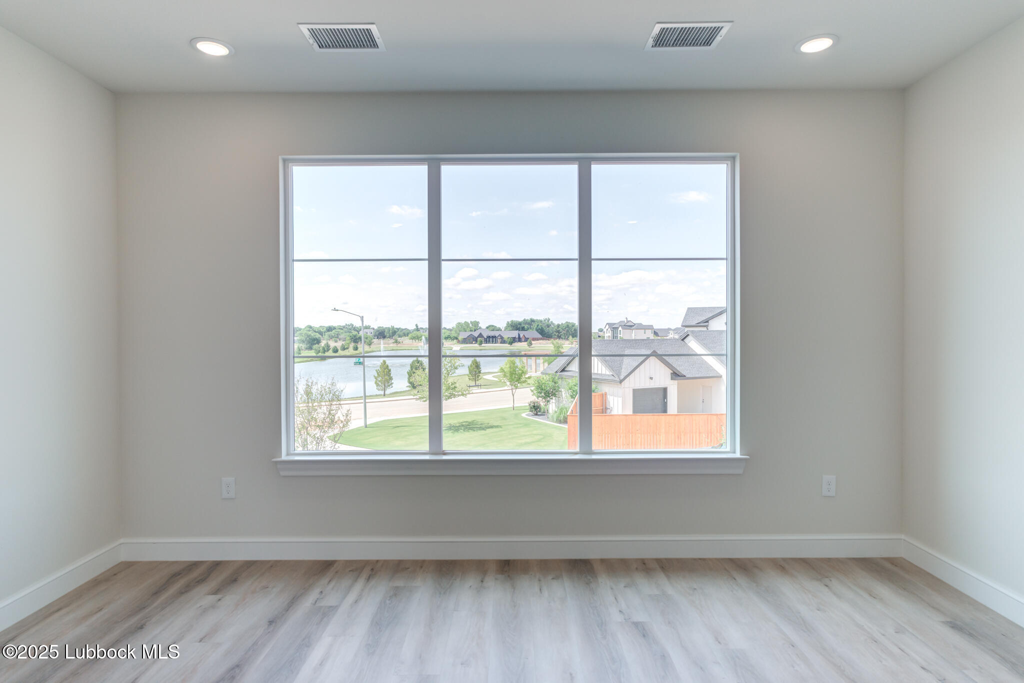 3902 148th Street Lubbock, TX 79423 - Photo 54 of 83 an empty room with wooden floor and windows