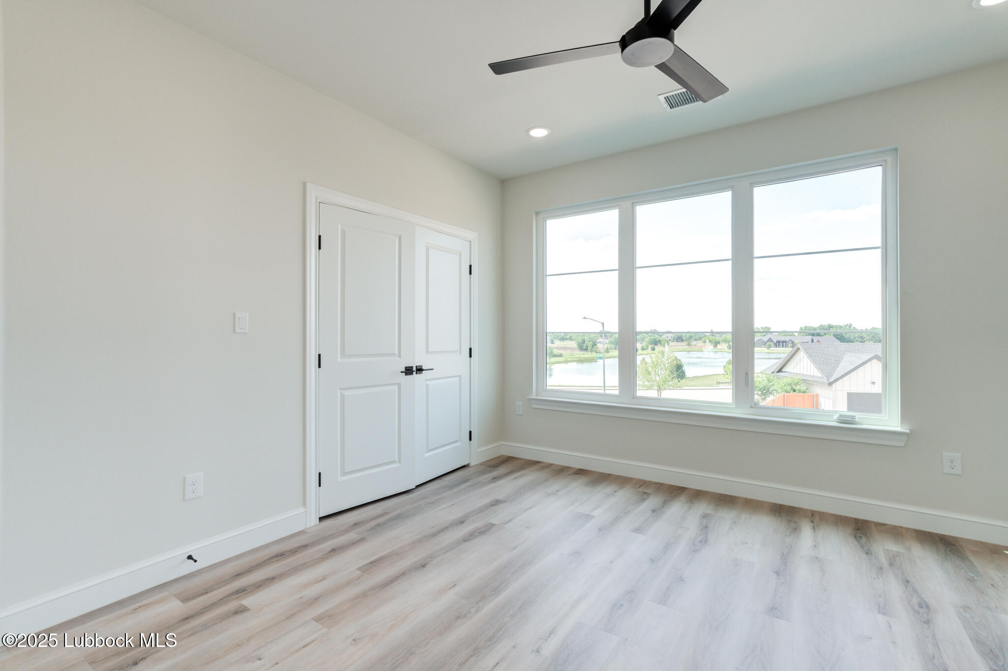 3902 148th Street Lubbock, TX 79423 - Photo 55 of 83 a view of an empty room with a window and wooden floor