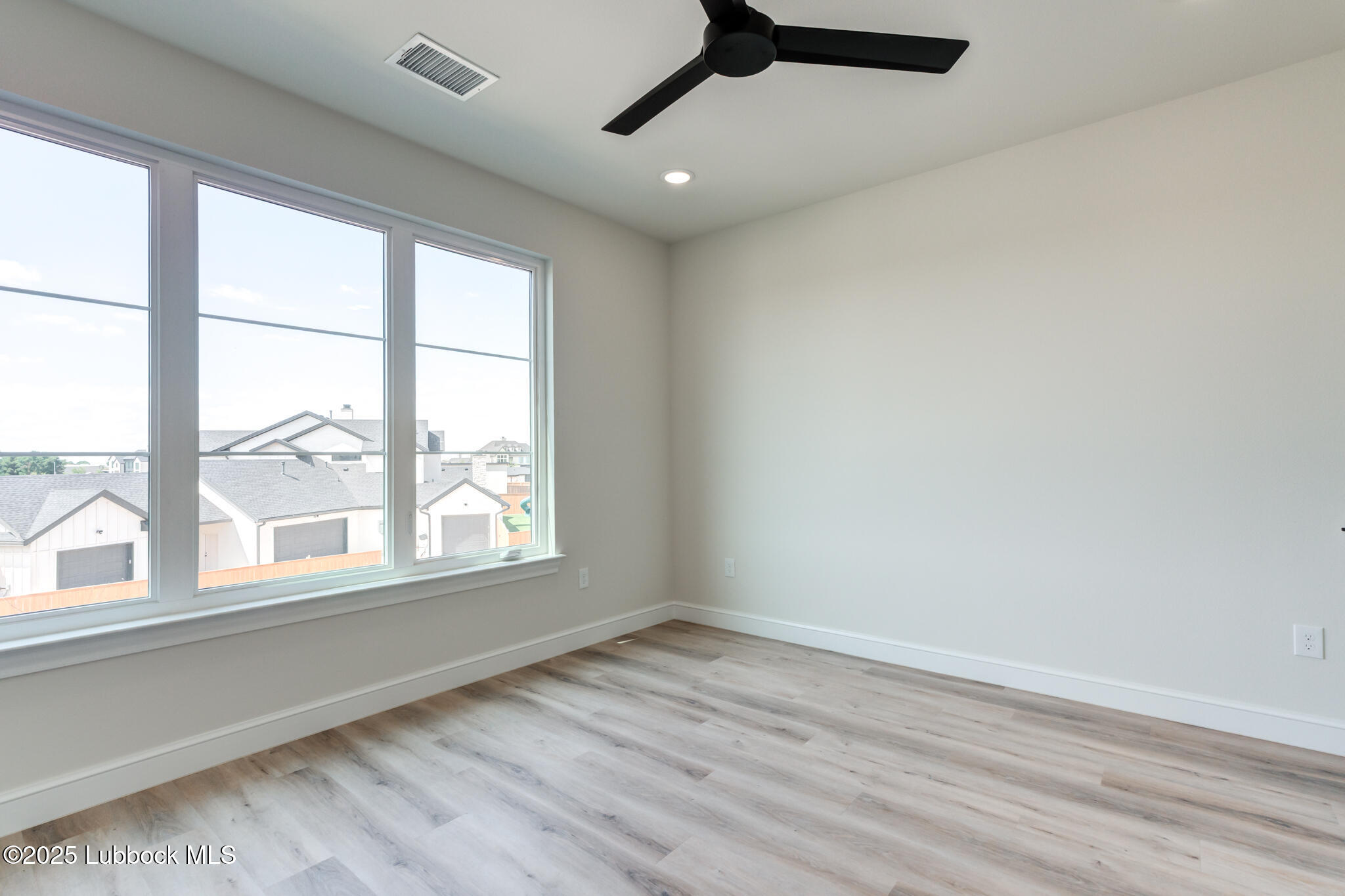 3902 148th Street Lubbock, TX 79423 - Photo 56 of 83 an empty room with wooden floor and windows