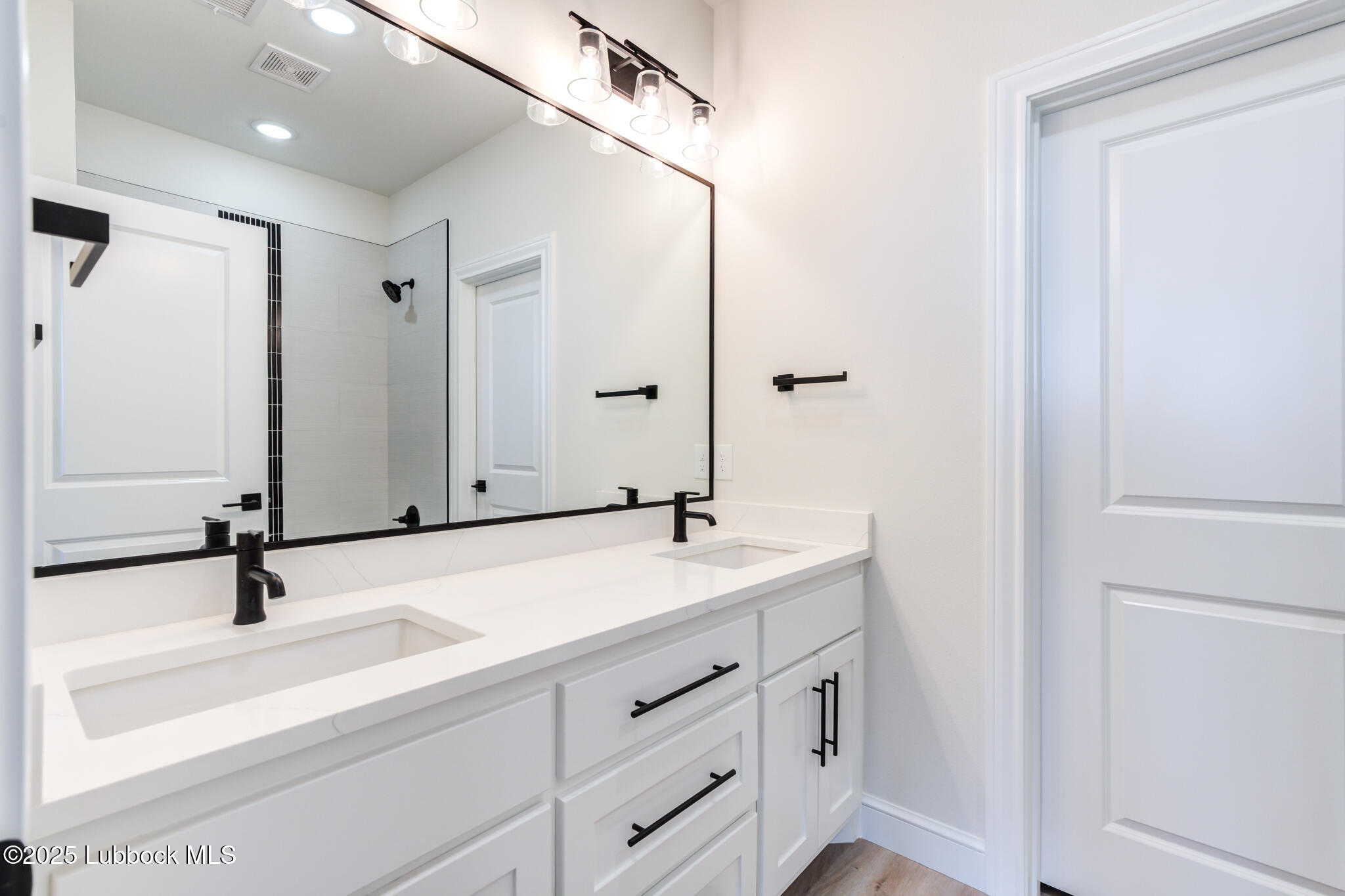 3902 148th Street Lubbock, TX 79423 - Photo 60 of 83 a bathroom with a sink and a mirror