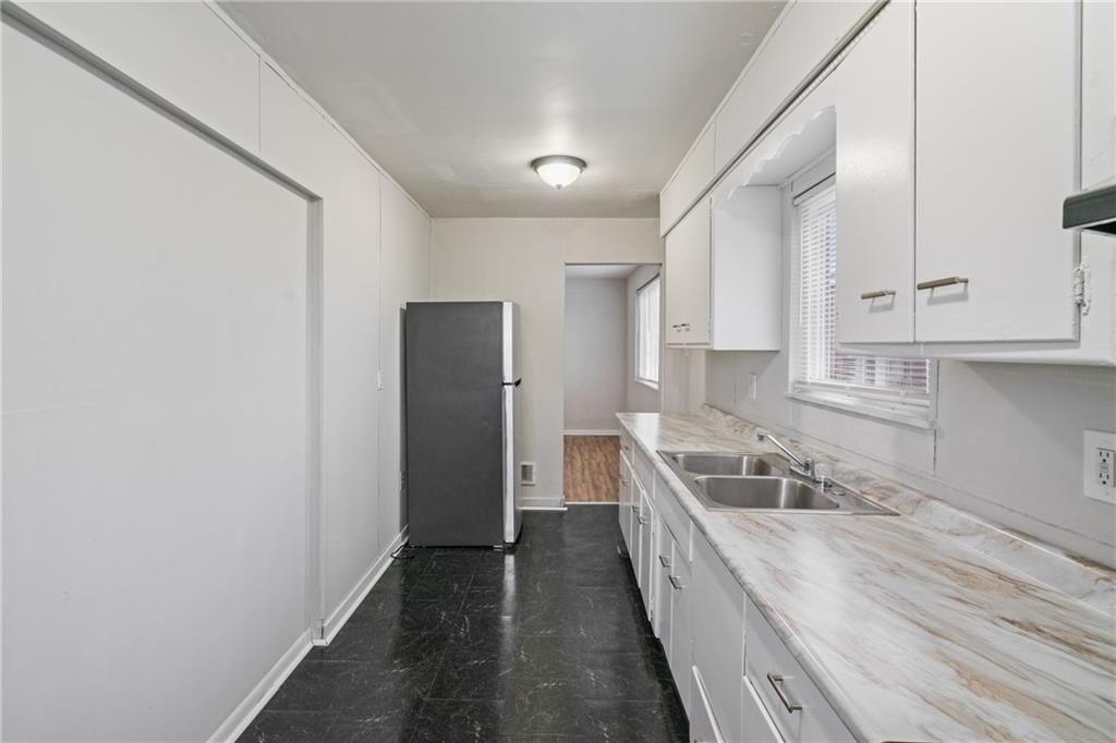 200 Moye Place Pittsburgh, PA 15210 - Photo 11 of 36 a kitchen with stainless steel appliances granite countertop a refrigerator a sink and white cabinets