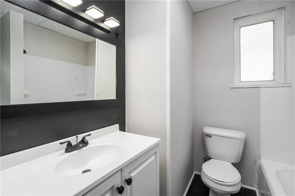 200 Moye Place Pittsburgh, PA 15210 - Photo 17 of 36 a bathroom with a toilet sink and mirror